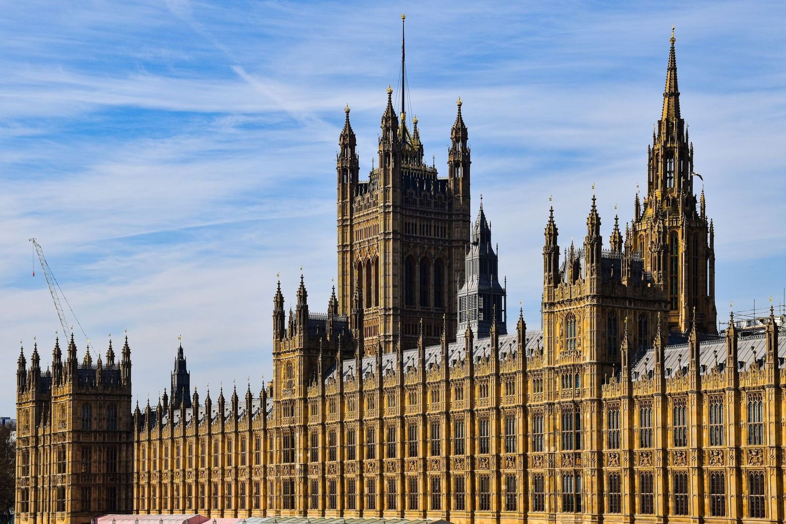 Ornate Palace of Westminster facade under a blue sky